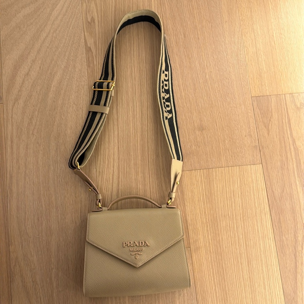 Tan leather handbag with black and tan guitar strap